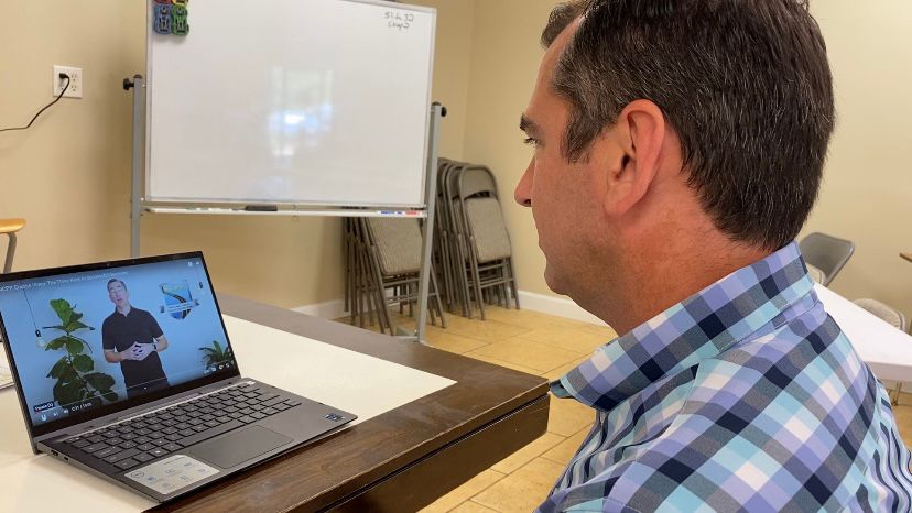 Joe Fitzgerald shows one of the videos available in the defensive driving course. (Spectrum News 1/Natalie Mooney)